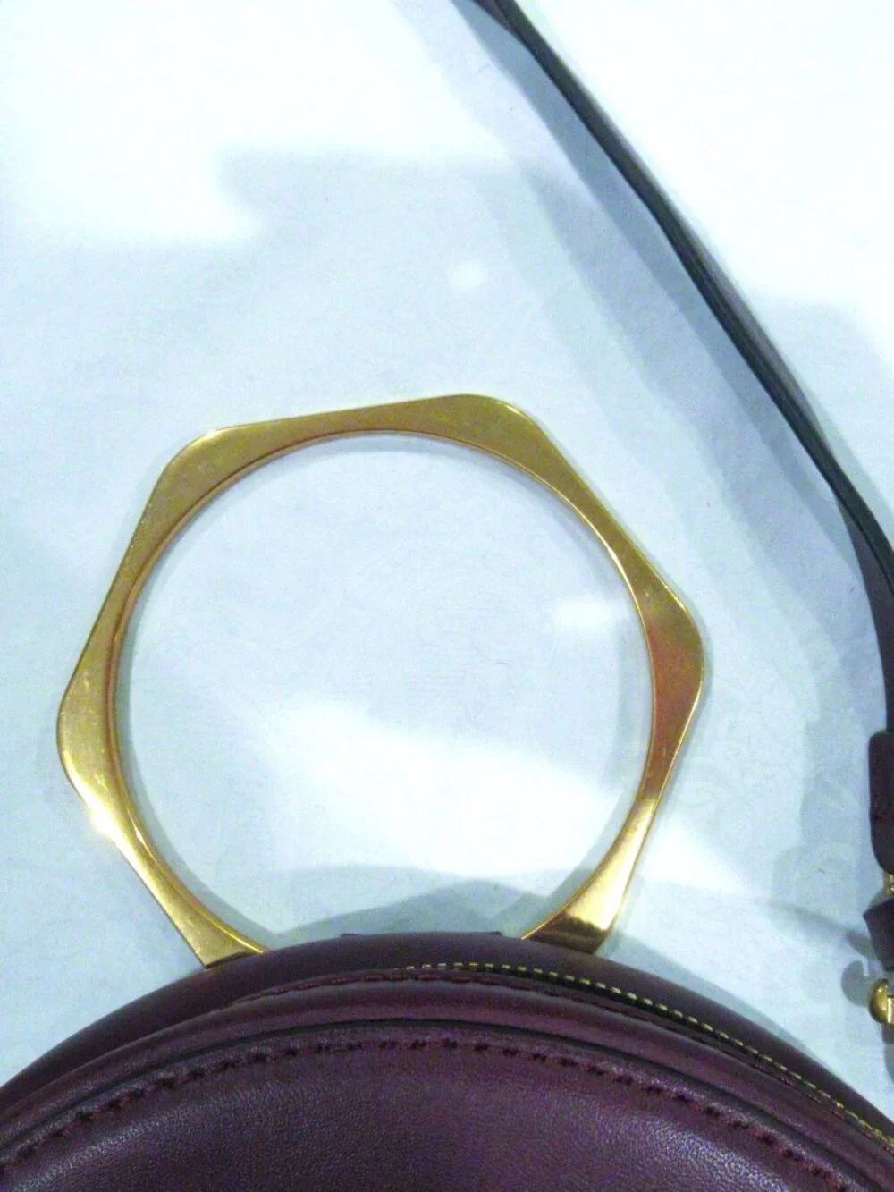 Thacker burgundy purse, both a crossbody and a bracelet handle